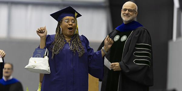 Excited student crossing the stage at graduation